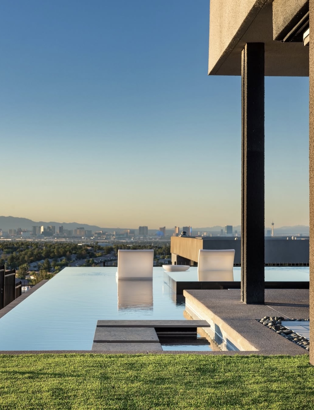 Luxury infinity pool overlooking Las Vegas skyline with modern architecture and pristine water